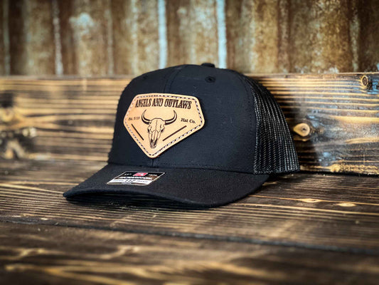 Black youth hat with Angels and Outlaws Co name and bison skull engraved on a leather patch